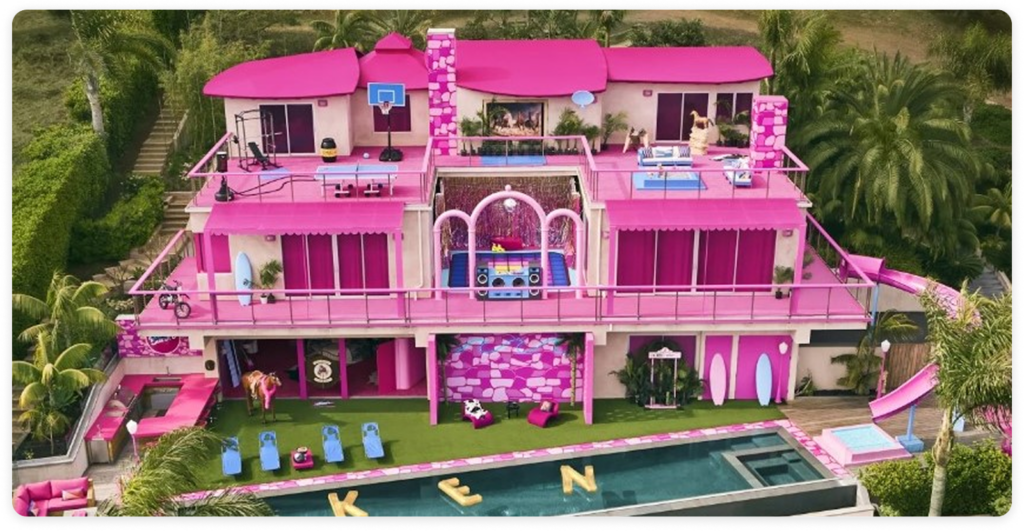 A bright pink Barbie Dreamhouse in Malibu with multiple levels.