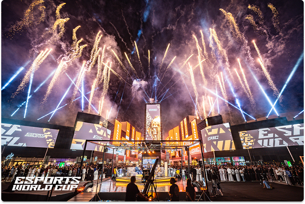 Fireworks over the Esports World Cup opening ceremony with a large crowd and stage.